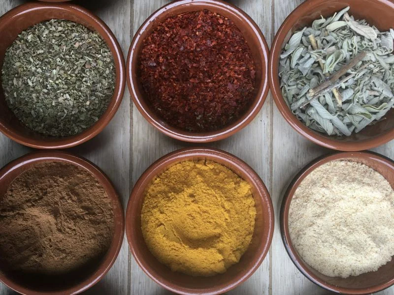 Terracotta bowls of single herbs and spices